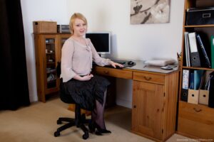 Shaggy babe Danniella takes it all off at her desk